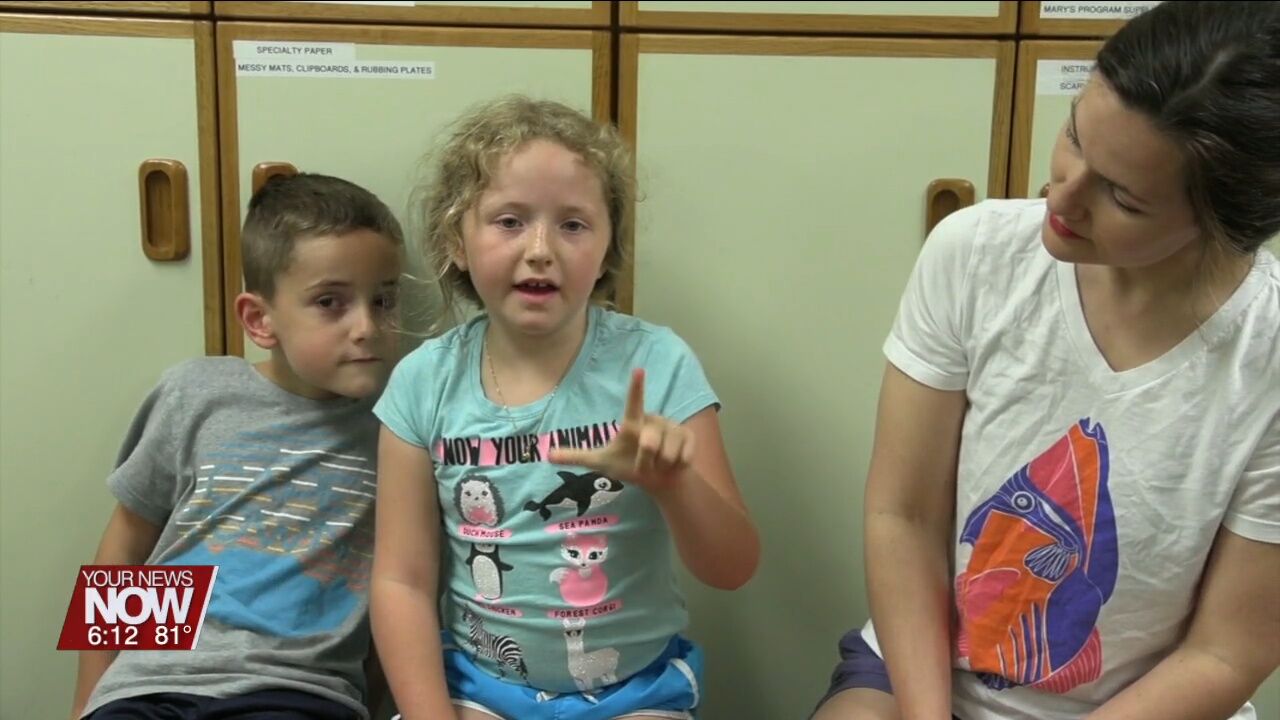 Children are learning basics of the American Sign Language at Lima Public Library